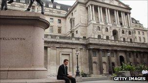 City worker sits alone outside Bank of England