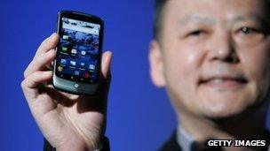 HTC CEO Peter Chau holding phone