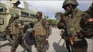 Ugandan peacekeepers from the African Union Mission in Somalia patrol Somalia"s capital Mogadishu, 20 August 2011