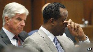 Conrad Murray wipes a tear from his eye during the opening statements of his trial