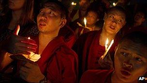 Exiled Tibetan monks hold a candlelight vigil in Dharamsala, India, as they react to reports that two Tibetan monks at the Kirti Monastery in Sichuan province set themselves on fire on 26 September