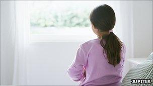 Girl staring out of a window