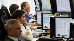 Trader watch their screens on the Troika Dialog trading floor in Moscow September 26, 2011. Falling oil prices and risk aversion sent the Russian rouble to its weakest level since mid-August 2009 and hit stocks after Prime Minister Vladimir Putin announced he would return to the Russian presidency.