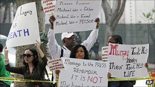 Fans hold signs in support of Michael Jackson outside LA courthouse