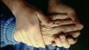 Elderly woman and helper