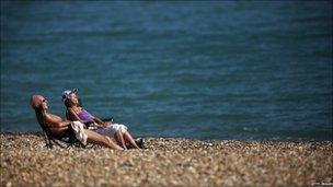 Couple sunbathing on Eastbourne beach