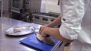 A chef filleting a fish