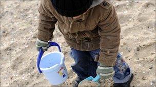 Boy digging in sand