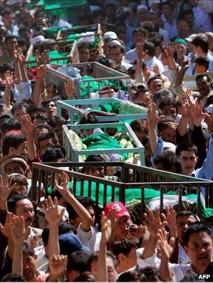 Pakistani Shia Muslims shout slogans as they carry coffins of slain community members during a funeral ceremony in Quetta on September 21, 2011