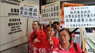 Protesters outside Hong Kong's High Court hold banners and shout slogans against the ruling of the court that immigration laws barring foreign domestic workers from applying for permanent residency were unconstitutional on September 30, 2011.