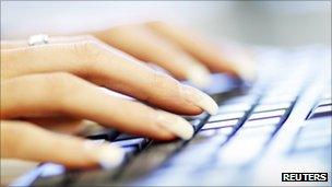 Woman typing on a computer keyboard