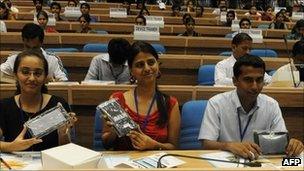 Indian students pose with Aakash computer tablet, 5 October 2011