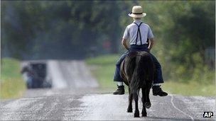 An Amish boy riding a horse