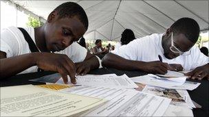 Job seekers fill out forms at a Congressional Black Caucus For The People job fair. 31 August 2011