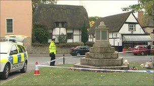 Police officer examining the damage