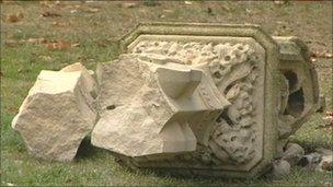 Part of the broken memorial lying on the grass