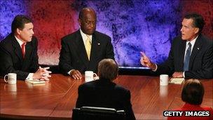 Rick Perry, Hermain Cain and Mitt Romney at the Bloomberg/Washington Post debate, 11 October 2011