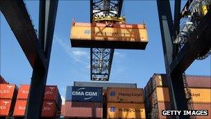 Cargo containers being moved at a port