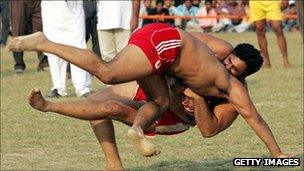 An Indian Kabaddi player (L) is brought to the ground during the 2008 Sri Guru Gobind Singh Kabaddi Series