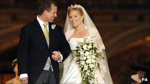 Peter Phillips, the eldest grandson of Queen Elizabeth II, and Canadian Autumn Kelly leave St. George's Chapel in Windsor, England, after their marriage ceremony