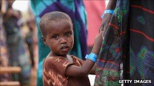 A child waits in the registration area of the Ifo refugee camp which makes up part of the giant Dadaab refugee settlement in Dadaab, Kenya