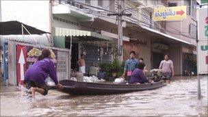 People in boat on flooded street. Photo: Nerriza Ballee