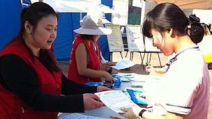 Jong-sun Woo (left) working on a mental health awareness street campaign