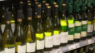 bottles of wine on supermarket shelf