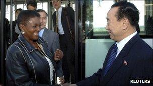 Valerie Amos, UN under-secretary-general for humanitarian affairs, and her party are greeted by a North Korean official upon their arrival at an airport in North Korea on Monday, in this picture released by North Korea's official news agency KCNA