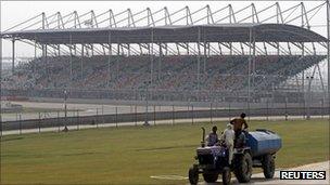 A tractor pulls a water tanker at the Buddh International Circuit, the venue for the first ever Indian Formula One race at Greater Noida,