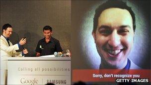 Two men demonstrating the facial recognition feature of the Samsung Galaxy Nexus mobile