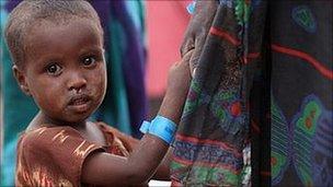 A child waits in the registration area of the Ifo refugee camp which makes up part of the giant Dadaab refugee settlement in Dadaab, Kenya