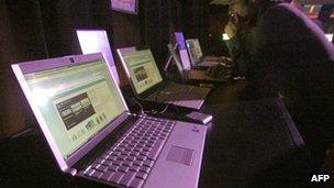 A man in front of a row of computers