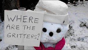 Snowman with gritter placard