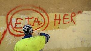 A municipal worker paints over graffiti reading "ETA, The People Are With You" in Guernica October 21, 2011