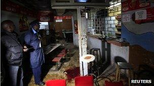 Police inspect the scene of an explosion inside a club in Kenya's capital Nairobi on 24 October 2011