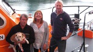 Nigel and Karen Large with their dog Ben and the St Helier lifeboat coxswain