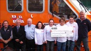 Lifeboat management alongside fundraisers on the St Helier all-weather Tamar class lifeboat