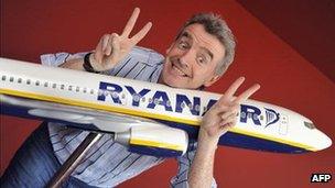 Mr O'Leary smiling with a model of a Ryanair plane