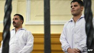 Egyptian undercover police officers Awad Ismail Suleiman (R) and Mahmud Salah Amin, convicted of killing Khaled Said last year, in Alexandria court - 24 September 2011