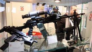 A man walks past guns on display at an exhibition for Libya's Defense, Security and Safety (file photo 2010)