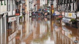 Flooded shops are viewed in Droitwich, Worcestershire. July 2007