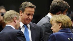 Prime Minister David Cameron (centre) talks with German Chancellor Angela Merkel