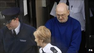 Robert Black being led from Lisburn Magistrates' Court in January 2010