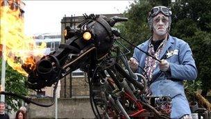 Man dressed in ghoulish costume on a metal sculptural horse