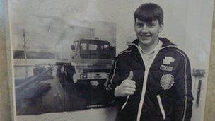 A boy and a picture of a HGV