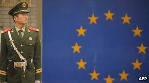 A Chinese paramilitary policeman stands guard outside the European Union Delegation in Beijing on 1 November 2011