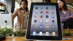 Customers look at the iPad 2 in South Korea