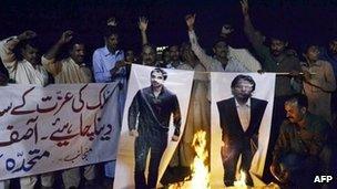 Pakistani protesters burn the photographs of former Pakistani cricketers Salman Butt and Mohmmad Asif during a protest in Multan on November 3, 2011.