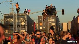 Protesters climb on trucks near the port of Oakland